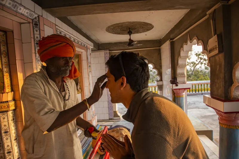 A village priest blessing Suyash Keshari at a temple